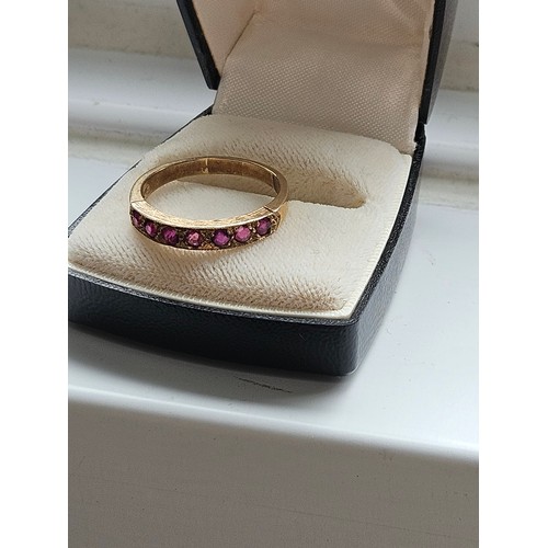 580D - 9ct yellow gold.
Ruby and diamond half eternity ring.
3.19g