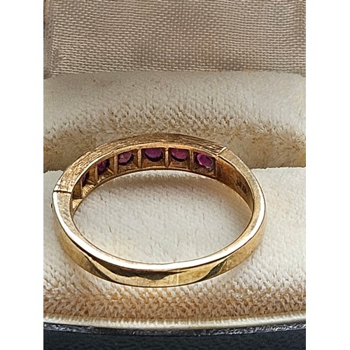 580D - 9ct yellow gold.
Ruby and diamond half eternity ring.
3.19g