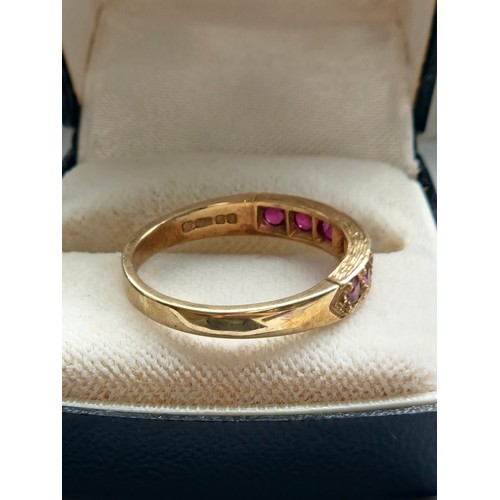 580D - 9ct yellow gold.
Ruby and diamond half eternity ring.
3.19g