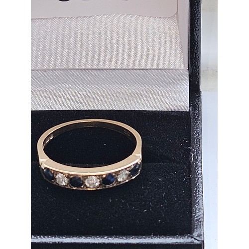 580F - 9ct yellow gold.
Diamond and sapphire half eternity ring.
2.7g