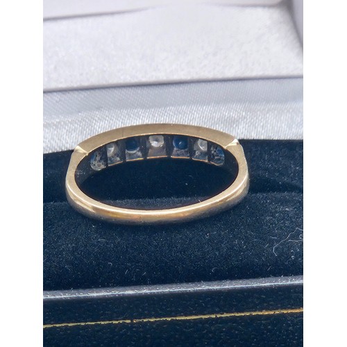 580F - 9ct yellow gold.
Diamond and sapphire half eternity ring.
2.7g