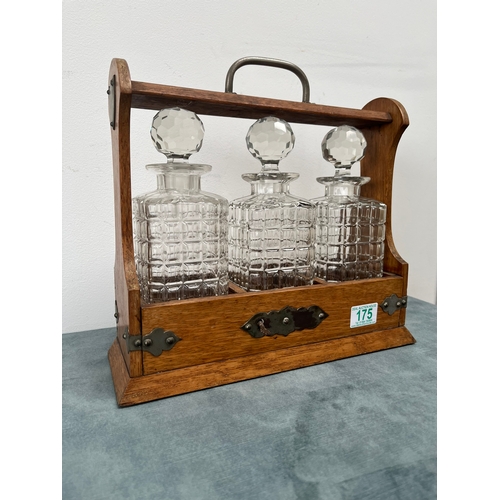 175 - Antique oak tantalus with three crystal decanters