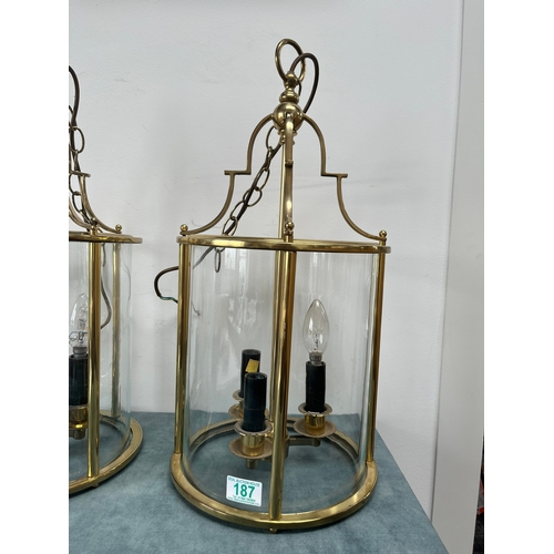 187 - Large pair of brass lantern ceiling lights. Shade is constructed of one piece of glass.