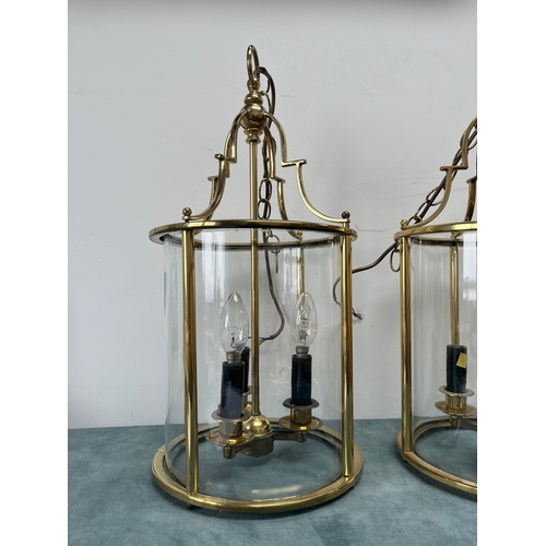 187 - Large pair of brass lantern ceiling lights. Shade is constructed of one piece of glass.