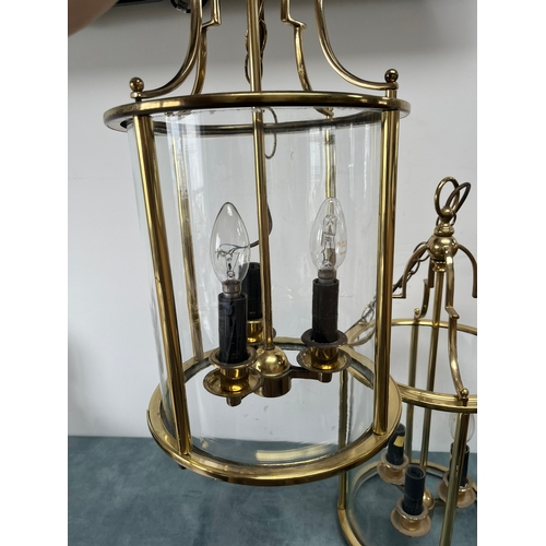 187 - Large pair of brass lantern ceiling lights. Shade is constructed of one piece of glass.