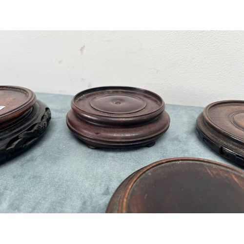 193 - Group of four Chinese oriental carved vase stands