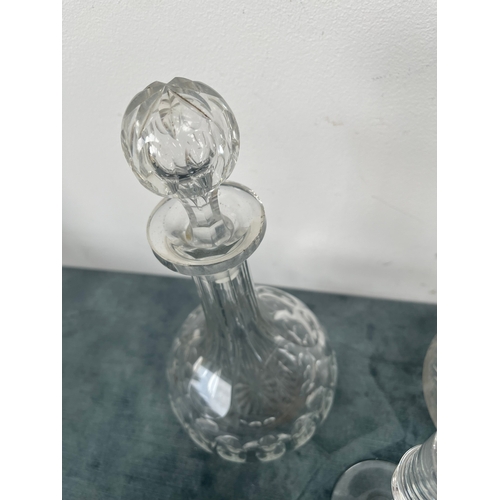 198 - 3 x Cut crystal decanters.
2 x Glass candlesticks