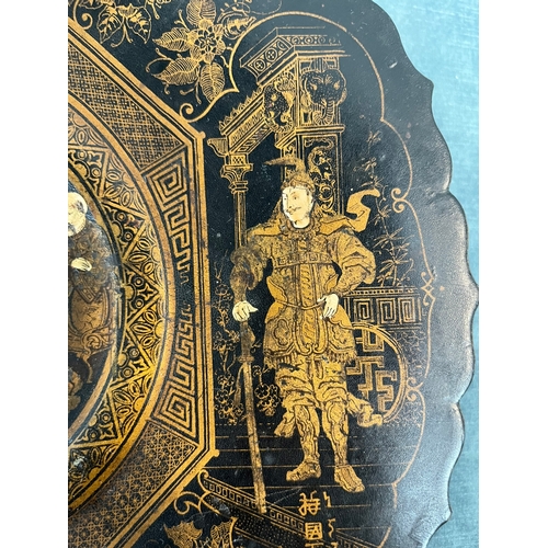 266 - Black lacquer oriental Chinese plate paper mache. Decorated with gold gilt and chinoiserie