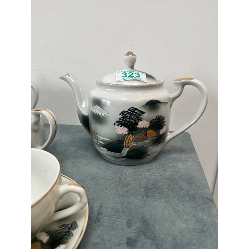 323 - Oriental Japanese bone China porcelain tea set. The cups feature geisha girls in the bases.