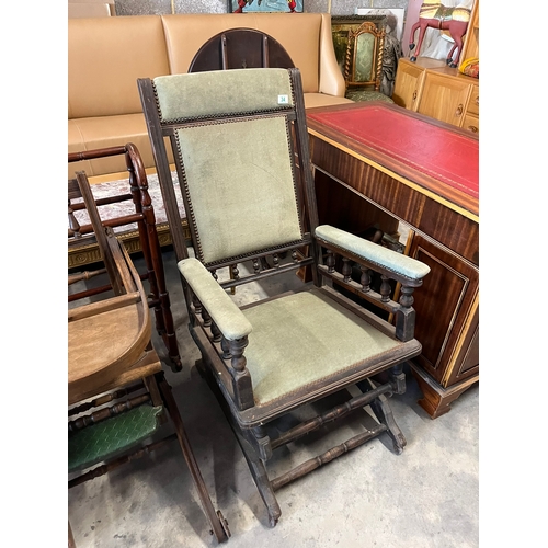 34 - Antique green upholstered rocking chair