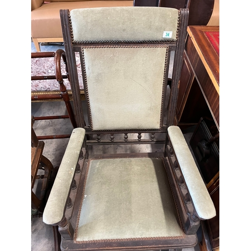 34 - Antique green upholstered rocking chair