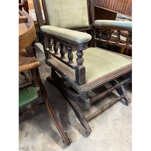 34 - Antique green upholstered rocking chair