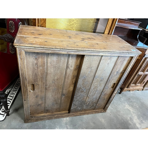 36 - Antique pine cupboard with sliding doors