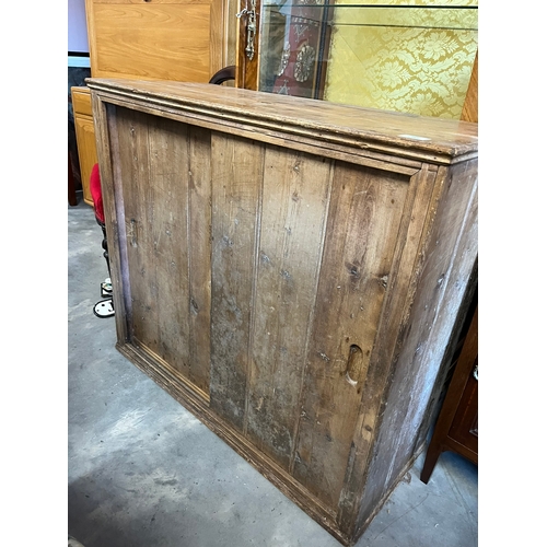 36 - Antique pine cupboard with sliding doors