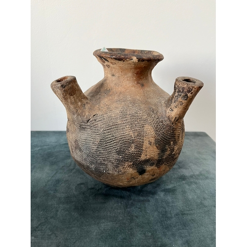 285 - A pottery vessel The baluster body with four protruding spouts