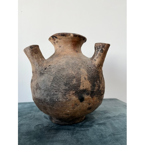 285 - A pottery vessel The baluster body with four protruding spouts