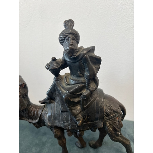 157 - Bronze model of a man sat on camel