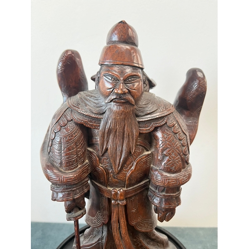 160 - Chinese carved hardwood model of a warrior. On a hardwood stand