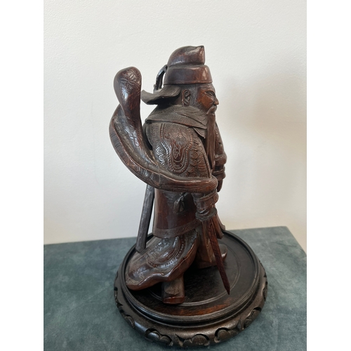 160 - Chinese carved hardwood model of a warrior. On a hardwood stand