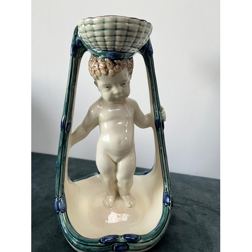 173 - Porcelain model of a cherub candle holder