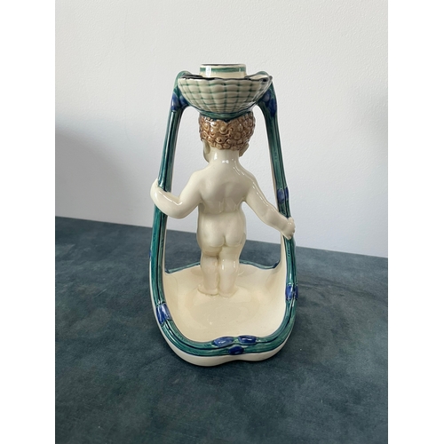 173 - Porcelain model of a cherub candle holder