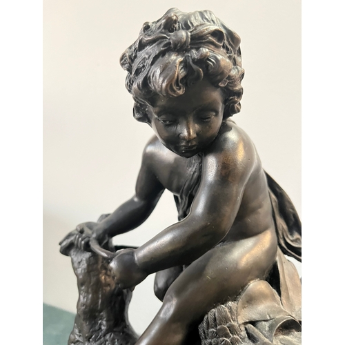 184 - Large modern bronze model of a cherub boy with a chicken. On marble base