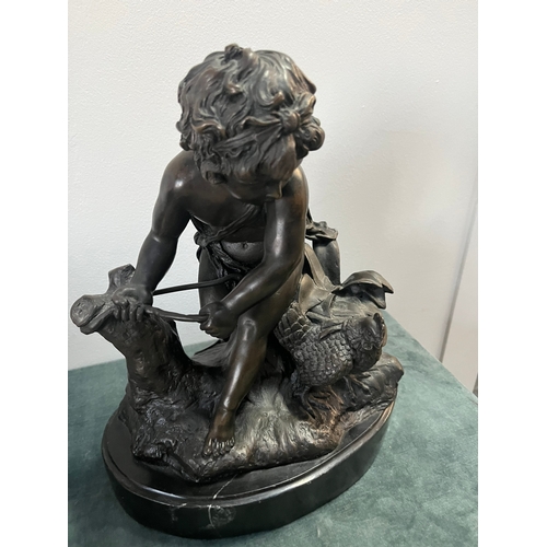 184 - Large modern bronze model of a cherub boy with a chicken. On marble base