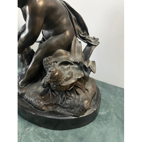 184 - Large modern bronze model of a cherub boy with a chicken. On marble base