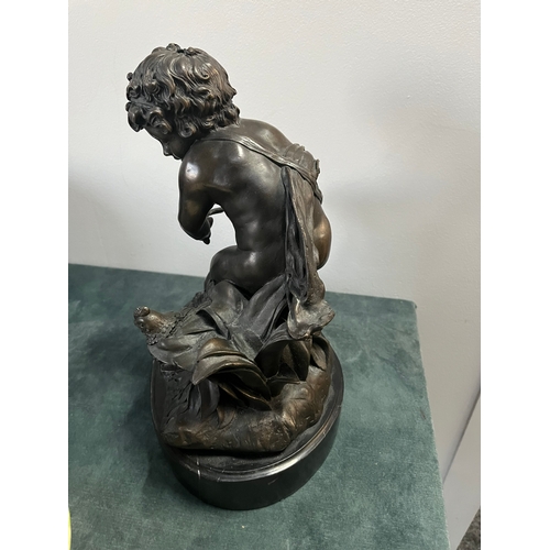 184 - Large modern bronze model of a cherub boy with a chicken. On marble base