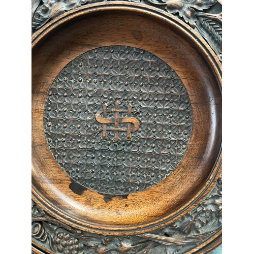 228 - Antique carved wood collection plate.  High quality carvings
29cm across