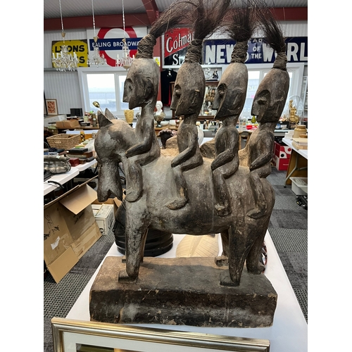 255 - Large central African carved tribal figure of four horse riders 

55cm wide x 80cm high