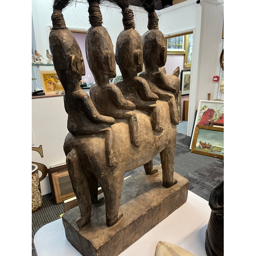 255 - Large central African carved tribal figure of four horse riders 

55cm wide x 80cm high