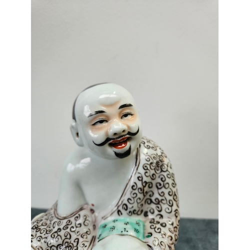 383 - Japanese porcelain figure of a seated man