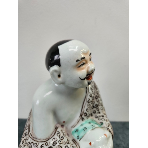 383 - Japanese porcelain figure of a seated man