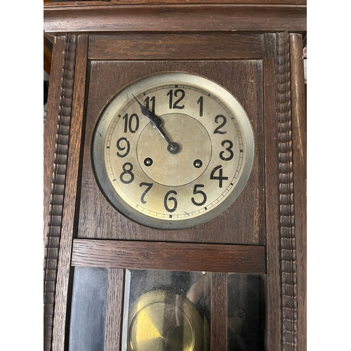 53 - 1930's wall clock with pendulum and key