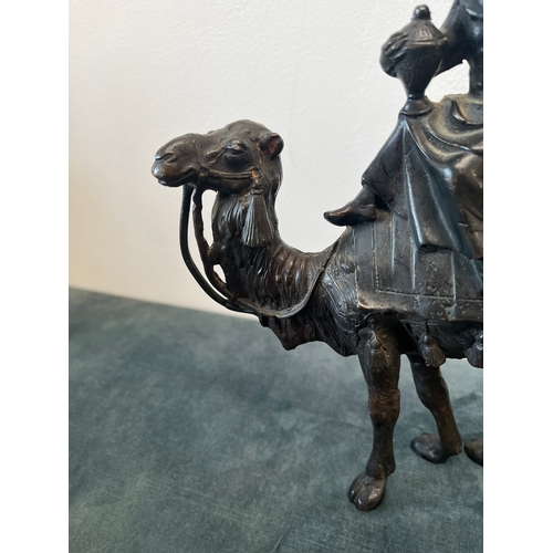 157 - Bronze model of a man sat on camel