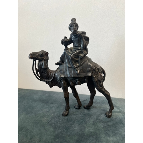 157 - Bronze model of a man sat on camel