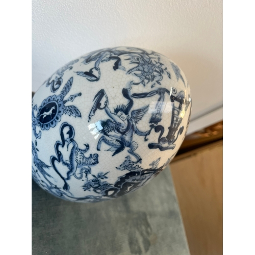 202 - Vintage blue and white egg decorated with cherubs and crests.