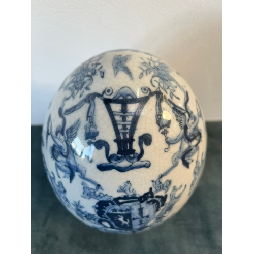 202 - Vintage blue and white egg decorated with cherubs and crests.