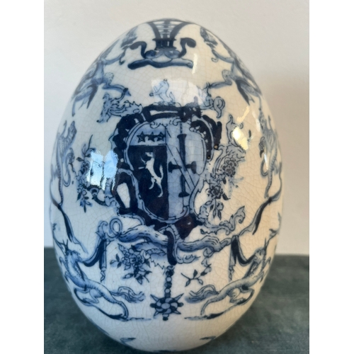 202 - Vintage blue and white egg decorated with cherubs and crests.