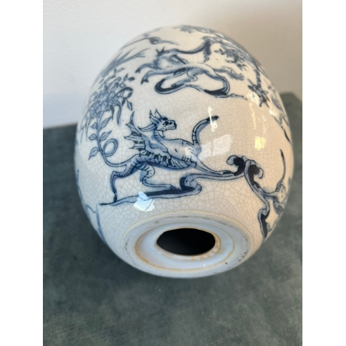 202 - Vintage blue and white egg decorated with cherubs and crests.