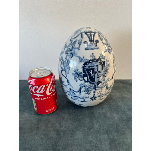 202 - Vintage blue and white egg decorated with cherubs and crests.