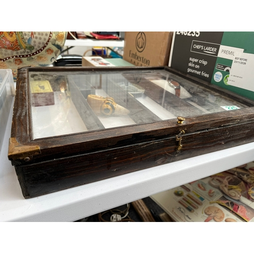 225 - Vintage table top display cabinet and contents