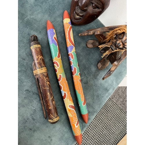 246 - 2 x Decorated dance poles? African carved mask and erotic seated man