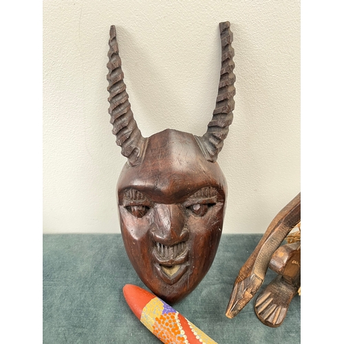 246 - 2 x Decorated dance poles? African carved mask and erotic seated man