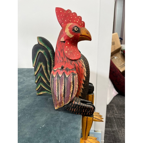 247 - Wooden carved seated chicken with swinging legs