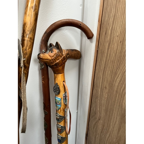 321 - 4 x walking sticks including antler handle, Huskey with badges.