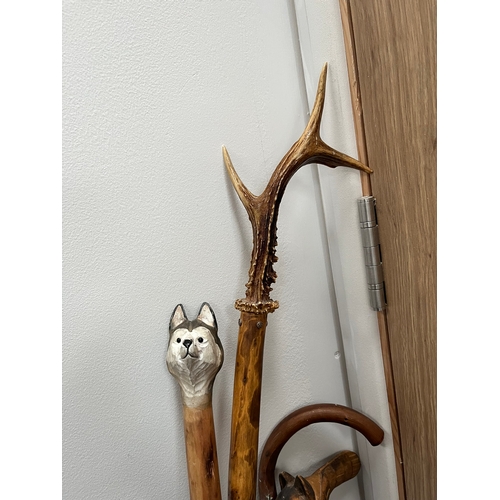 321 - 4 x walking sticks including antler handle, Huskey with badges.