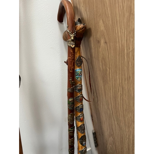 321 - 4 x walking sticks including antler handle, Huskey with badges.