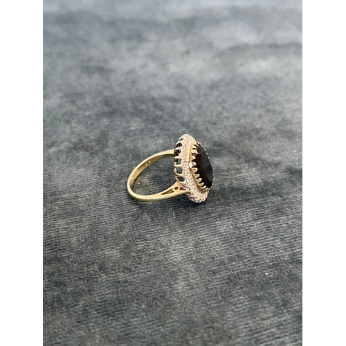 514 - 9ct yellow gold and diamond ring with a possible tourmaline